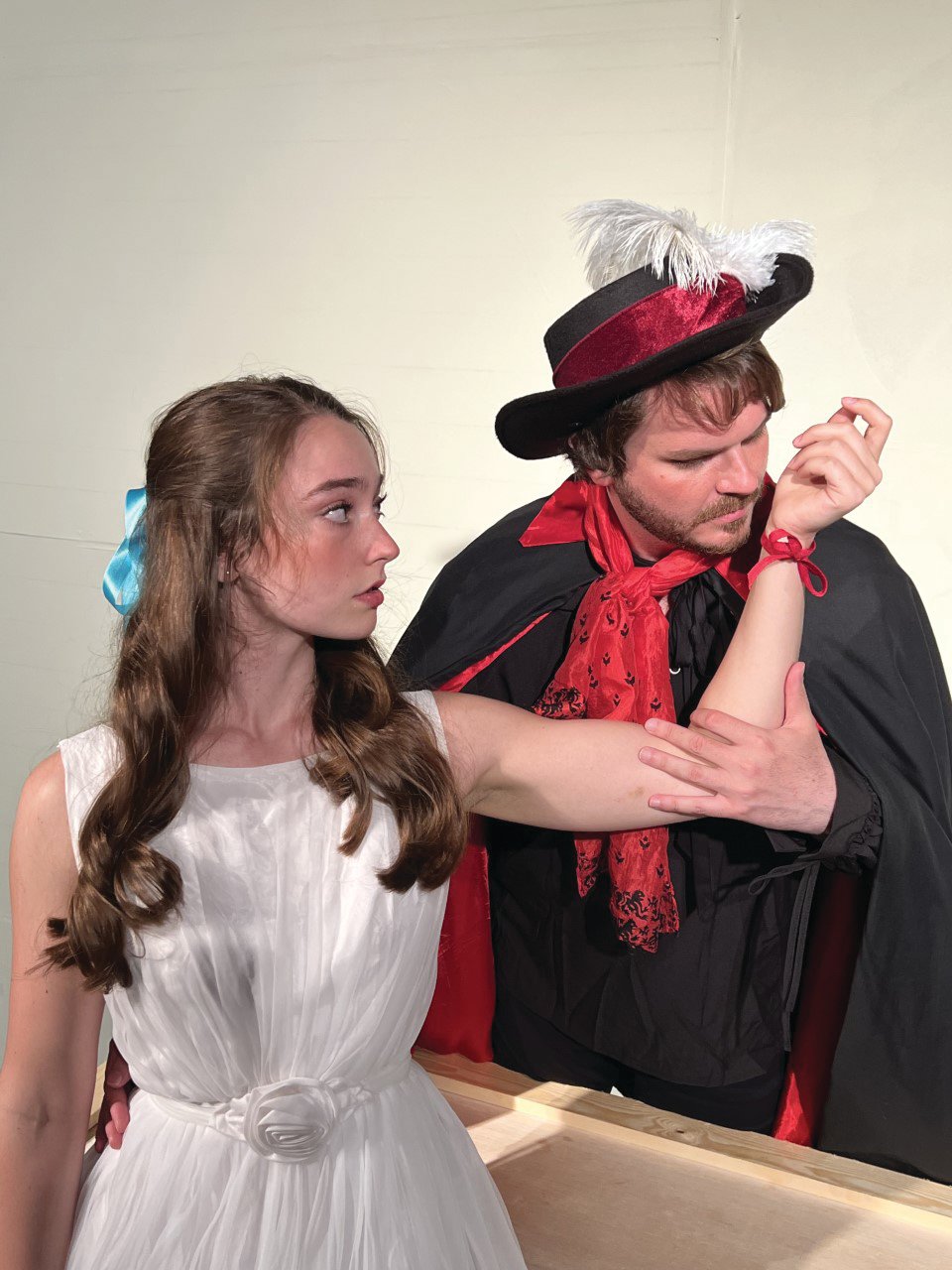 El Gallo (Jordan Jones) admires the red ribbon Luisa (Emmie Wright) has placed on the spot where he first touched her. The Fantasticks opens Wednesday at Myers Dinner Theatre.